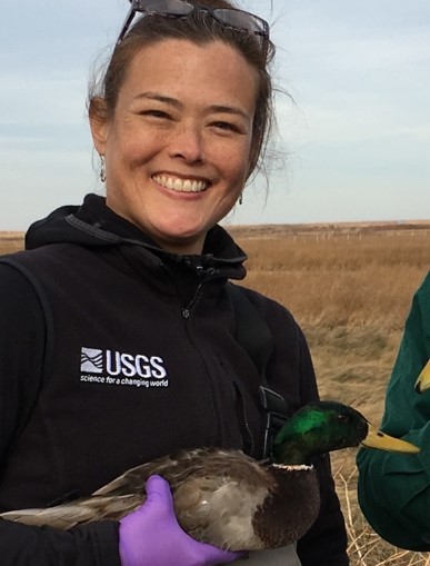 Portrait photo of Diann holding a mallard duck